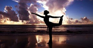 Woman Doing Yoga on Beach