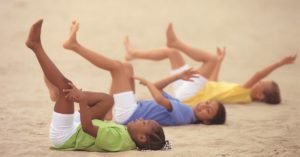 children in pedal laughing pose