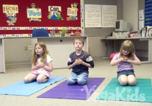 kids doing yoga in class room